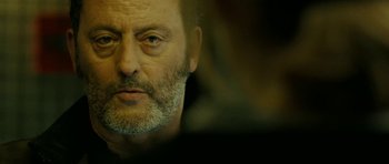 Movie still from “22 Bullets” (2010), directed by Richard Berry – A person with a beard; Close Up shot, Over the shoulder angle