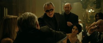 Movie still from “22 Bullets” (2010), directed by Richard Berry – A group of people standing next to each other in front of a mirror; Medium shot, Over the shoulder angle