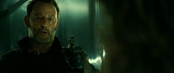 Movie still from “22 Bullets” (2010), directed by Richard Berry – A person holding a gun; Close Up shot, Low angle