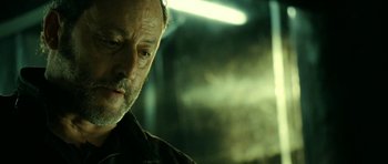 Movie still from “22 Bullets” (2010), directed by Richard Berry – A person wearing a jacket; Close Up shot, Over the shoulder angle