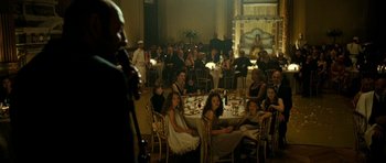 Movie still from “22 Bullets” (2010), directed by Richard Berry – A group of people sitting at a table with food; Wide shot, High angle