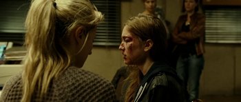 Movie still from “22 Bullets” (2010), directed by Richard Berry – Two people with makeup on their faces and one of them has a bruise on her face; Close Up shot, Over the shoulder angle