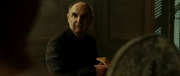 Movie still from “22 Bullets” (2010), directed by Richard Berry – A man holding a piece of pizza in his hand; Close Up shot, Over the shoulder angle