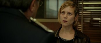 Movie still from “22 Bullets” (2010), directed by Richard Berry – A woman in black shirt looking at a man in black jacket; Close Up shot, Over the shoulder angle