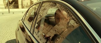 Movie still from “22 Bullets” (2010), directed by Richard Berry – A woman looking out of the window of a car; Close Up shot, Low angle