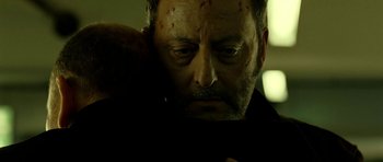 Movie still from “22 Bullets” (2010), directed by Richard Berry – A person holding a teddy bear; Close Up shot, Over the shoulder angle