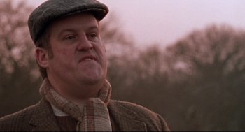 Movie still from “24 Hour Party People” (2002), directed by Tom Bruggen – An older man wearing a hat and a jacket; Close Up shot, Low angle