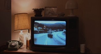 Movie still from “24 Hour Party People” (2002), directed by Tom Bruggen – A television set with a picture of a car going down the road; Extreme Close Up shot, High angle
