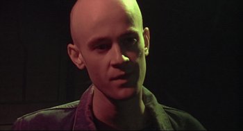 Movie still from “24 Hour Party People” (2002), directed by Tom Bruggen – A man with a bald head is looking at the camera; Close Up shot, Low angle