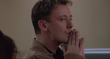 Movie still from “24 Hour Party People” (2002), directed by Tom Bruggen – A man with his hands over his mouth; Close Up shot, Low angle