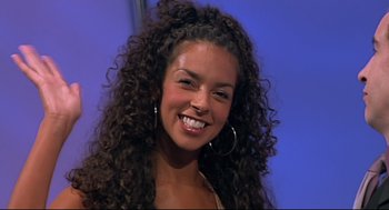 Movie still from “24 Hour Party People” (2002), directed by Tom Bruggen – A beautiful young lady with long brown curly hair; Close Up shot, High angle
