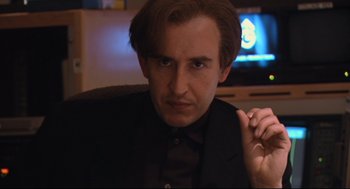 Movie still from “24 Hour Party People” (2002), directed by Tom Bruggen – A person wearing a suit and tie; Close Up shot, Low angle