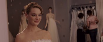 Movie still from “27 Dresses” (2008), directed by Anne Fletcher – A beautiful young woman in a wedding dress; Close Up shot, Over the shoulder angle
