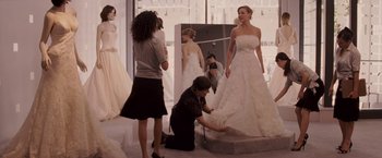 Movie still from “27 Dresses” (2008), directed by Anne Fletcher – A woman in a wedding dress looking in the mirror; Wide shot, Over the shoulder angle