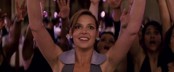 Movie still from “27 Dresses” (2008), directed by Anne Fletcher – A group of people raising their hands in the air; Close Up shot, Low angle