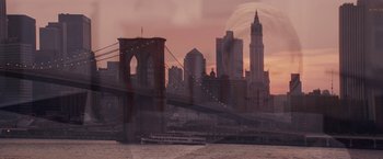 Movie still from “27 Dresses” (2008), directed by Anne Fletcher – A view of a bridge and a boat in the water at sunset; Extreme Wide shot, Over the shoulder angle