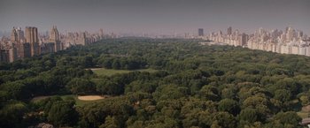Movie still from “27 Dresses” (2008), directed by Anne Fletcher – An aerial view of a park and a city skyline; Extreme Wide shot, High angle