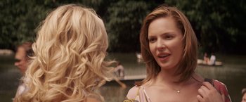 Movie still from “27 Dresses” (2008), directed by Anne Fletcher – Two women talking to each other in front of a body of water; Close Up shot, Over the shoulder angle