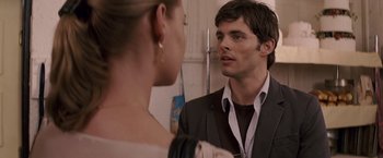 Movie still from “27 Dresses” (2008), directed by Anne Fletcher – A man and a woman looking at one another in a mirror; Close Up shot, Over the shoulder angle