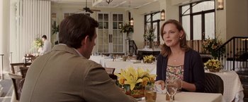 Movie still from “27 Dresses” (2008), directed by Anne Fletcher – A man and a woman are sitting at a table; Medium shot, Over the shoulder angle