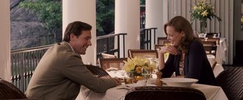 Movie still from “27 Dresses” (2008), directed by Anne Fletcher – A man and a woman are sitting at a table together; Medium shot, Over the shoulder angle