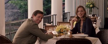Movie still from “27 Dresses” (2008), directed by Anne Fletcher – A man and a woman are sitting at a table; Medium shot, Over the shoulder angle