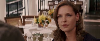 Movie still from “27 Dresses” (2008), directed by Anne Fletcher – A person sitting at a table; Close Up shot, Over the shoulder angle