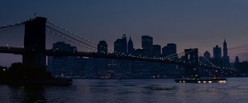 Movie still from “27 Dresses” (2008), directed by Anne Fletcher – A view of a city skyline at night with a bridge in the middle of it; Extreme Wide shot, High angle