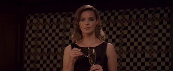 Movie still from “27 Dresses” (2008), directed by Anne Fletcher – A beautiful woman holding a glass of champagne; Close Up shot, Over the shoulder angle