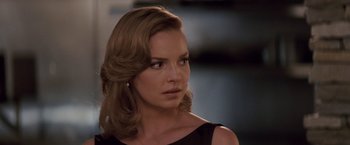 Movie still from “27 Dresses” (2008), directed by Anne Fletcher – A woman in a black dress looking to her left; Close Up shot, Over the shoulder angle