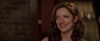 Movie still from “27 Dresses” (2008), directed by Anne Fletcher – A person smiling; Close Up shot, Over the shoulder angle