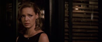 Movie still from “27 Dresses” (2008), directed by Anne Fletcher – A person wearing a black dress; Close Up shot, Over the shoulder angle