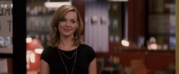 Movie still from “27 Dresses” (2008), directed by Anne Fletcher – A woman in a black shirt is smiling for the camera; Close Up shot, Over the shoulder angle