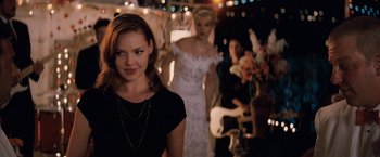 Movie still from “27 Dresses” (2008), directed by Anne Fletcher – A woman standing next to a man in a wedding dress; Medium shot, Over the shoulder angle
