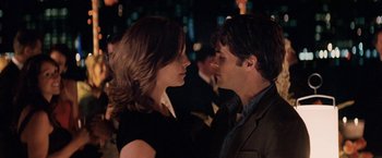 Movie still from “27 Dresses” (2008), directed by Anne Fletcher – A man and a woman standing next to each other; Close Up shot, Over the shoulder angle