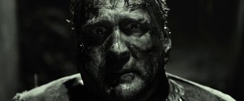 Movie still from “31” (2016), directed by Rob Zombie – A person's face covered in mud; Close Up shot, Low angle