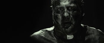 Movie still from “31” (2016), directed by Rob Zombie – A person with a face covered in mud; Close Up shot, Over the shoulder angle