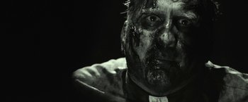 Movie still from “31” (2016), directed by Rob Zombie – A person with blood all over his face; Extreme Close Up shot, Over the shoulder angle