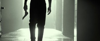 Movie still from “31” (2016), directed by Rob Zombie – A person walking down a street in the rain; Extreme Close Up shot, Low angle