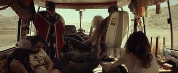 Movie still from “31” (2016), directed by Rob Zombie – A woman sitting in the driver's seat of an rv; Wide shot, Low angle
