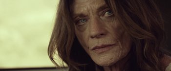 Movie still from “31” (2016), directed by Rob Zombie – An older woman with blue eyes looking at the camera; Close Up shot, Low angle