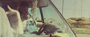 Movie still from “31” (2016), directed by Rob Zombie – A man sitting in the driver's seat of a truck; Medium shot, Low angle