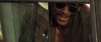 Movie still from “31” (2016), directed by Rob Zombie – A person wearing sunglasses; Close Up shot, Low angle