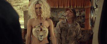 Movie still from “31” (2016), directed by Rob Zombie – A man and a woman wearing animal print clothing; Medium shot, Over the shoulder angle