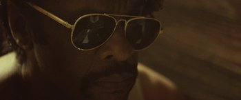 Movie still from “31” (2016), directed by Rob Zombie – A person wearing a pair of sunglasses; Extreme Close Up shot, Low angle
