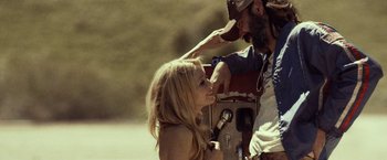 Movie still from “31” (2016), directed by Rob Zombie – A man and a woman are standing next to each other; Medium shot, Over the shoulder angle