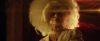 Movie still from “31” (2016), directed by Rob Zombie – An older woman with a large white wig on her head; Close Up shot, Low angle