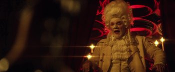 Movie still from “31” (2016), directed by Rob Zombie – A man dressed as a man in a white wig; Medium shot, Low angle