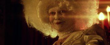 Movie still from “31” (2016), directed by Rob Zombie – An old woman with a white wig and a white hat; Close Up shot, Low angle