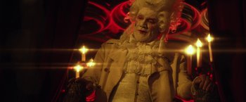 Movie still from “31” (2016), directed by Rob Zombie – An old man dressed as a man in a wig; Medium shot, Low angle